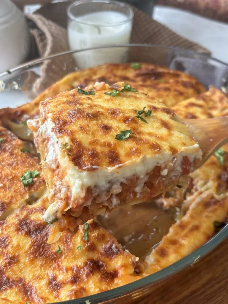 a slice of vegetarian moussaka being removed from the pan