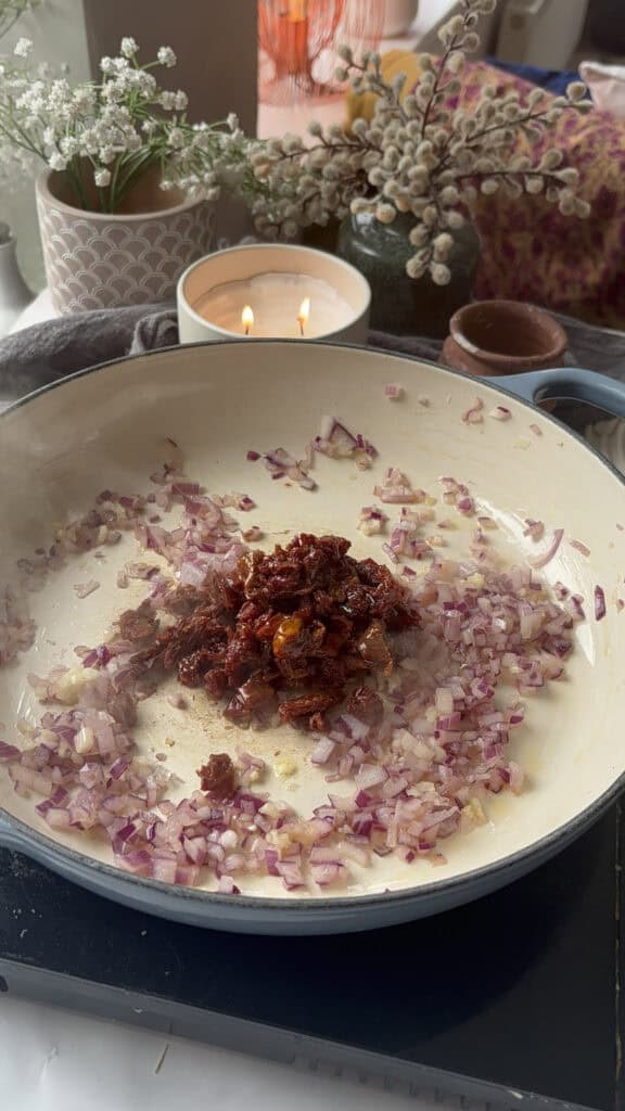 chopped sun-dried tomatoes and tomato paste added to the red onion and garlic