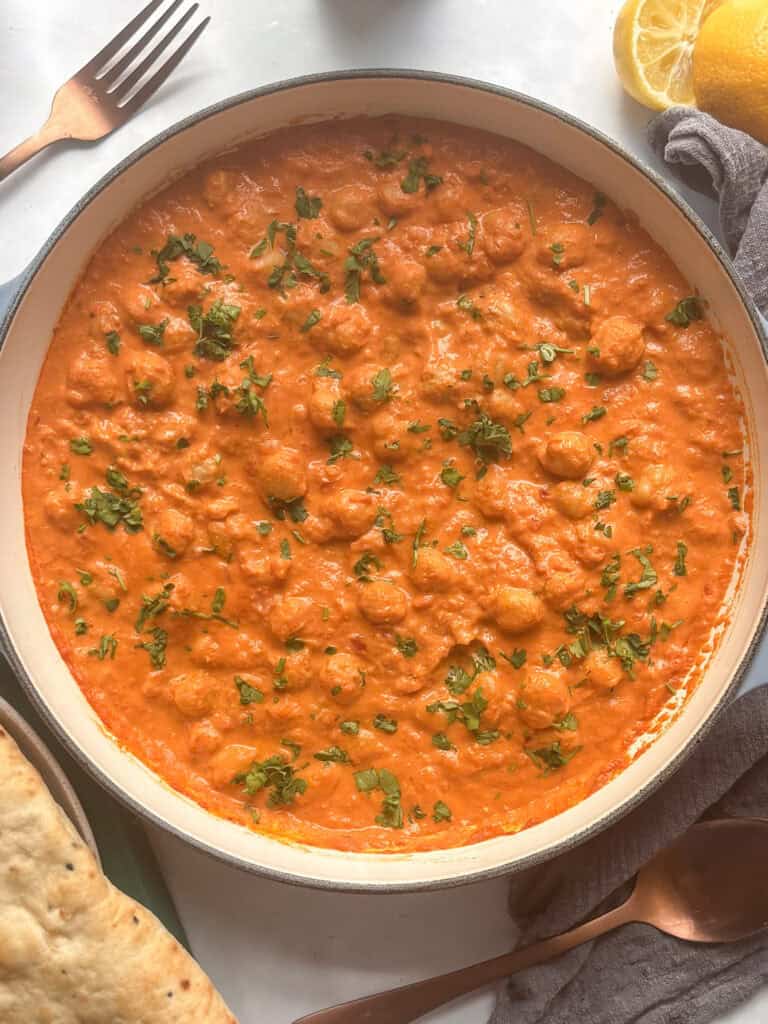 a pan of Indian butter chickpea curry topped with fresh cilantro