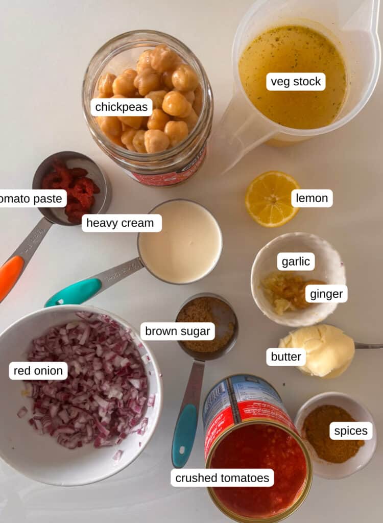 Indian butter chickpeas ingredients list: chickpeas, veg stock, tomato paste, heavy cream, lemon, garlic, ginger, brown sugar, red onion, crushed tomatoes, and spices