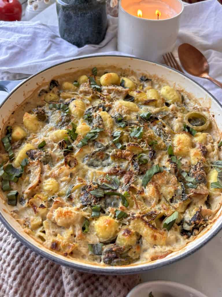 a close up shot of this creamy leek and gnocchi bake