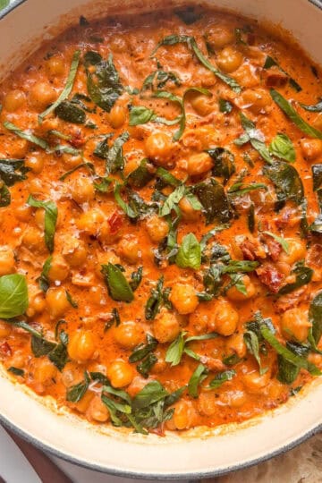 a pan of one-pot easy marry me chickpeas with spinach and fresh basil