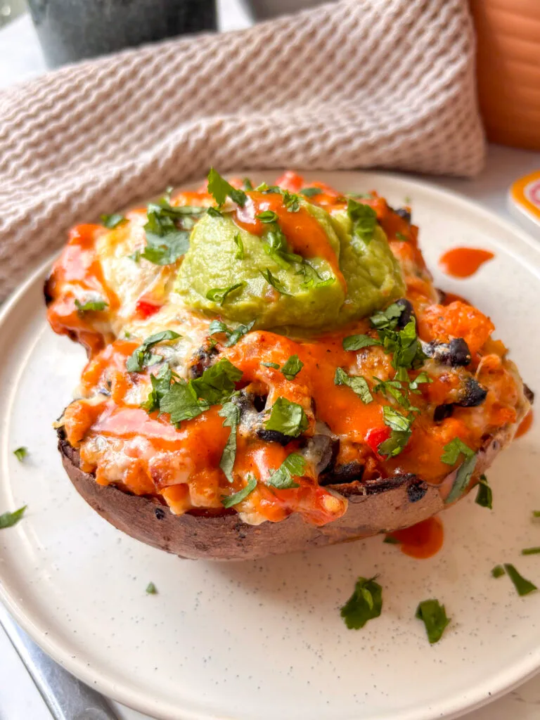 a white plate of mexican stuffed sweet potatoes