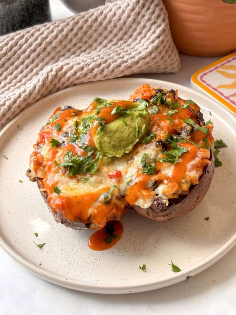 a white plate of mexican stuffed sweet potatoes