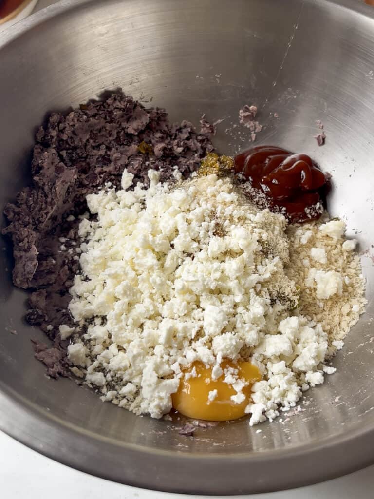 all the black bean burger ingredients in a mixing bowl ready to be combined
