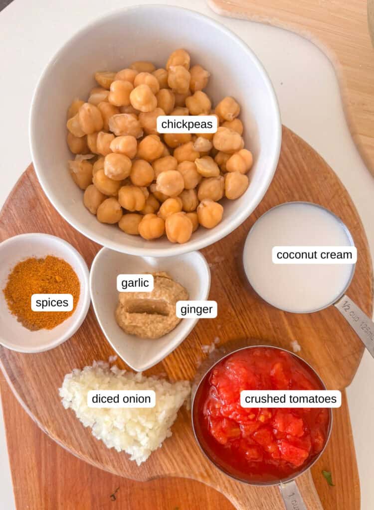 coconut chickpea curry ingredients shot: chickpeas, coconut cream, garlic, ginger, spices, crushed tomatoes, onion