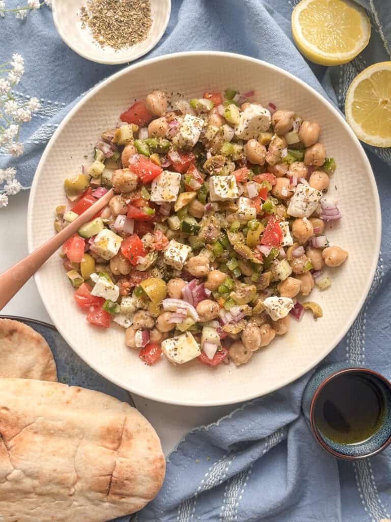 Greek salad in a bowl with chickpeas added