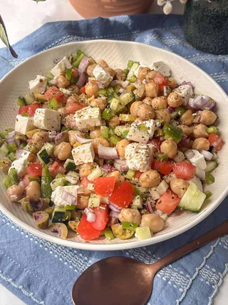 Greek salad in a bowl with chickpeas added