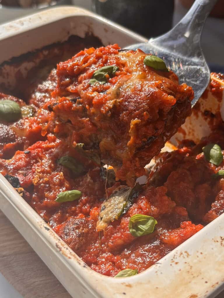 eggplant parmigiana layers being removed from the pan