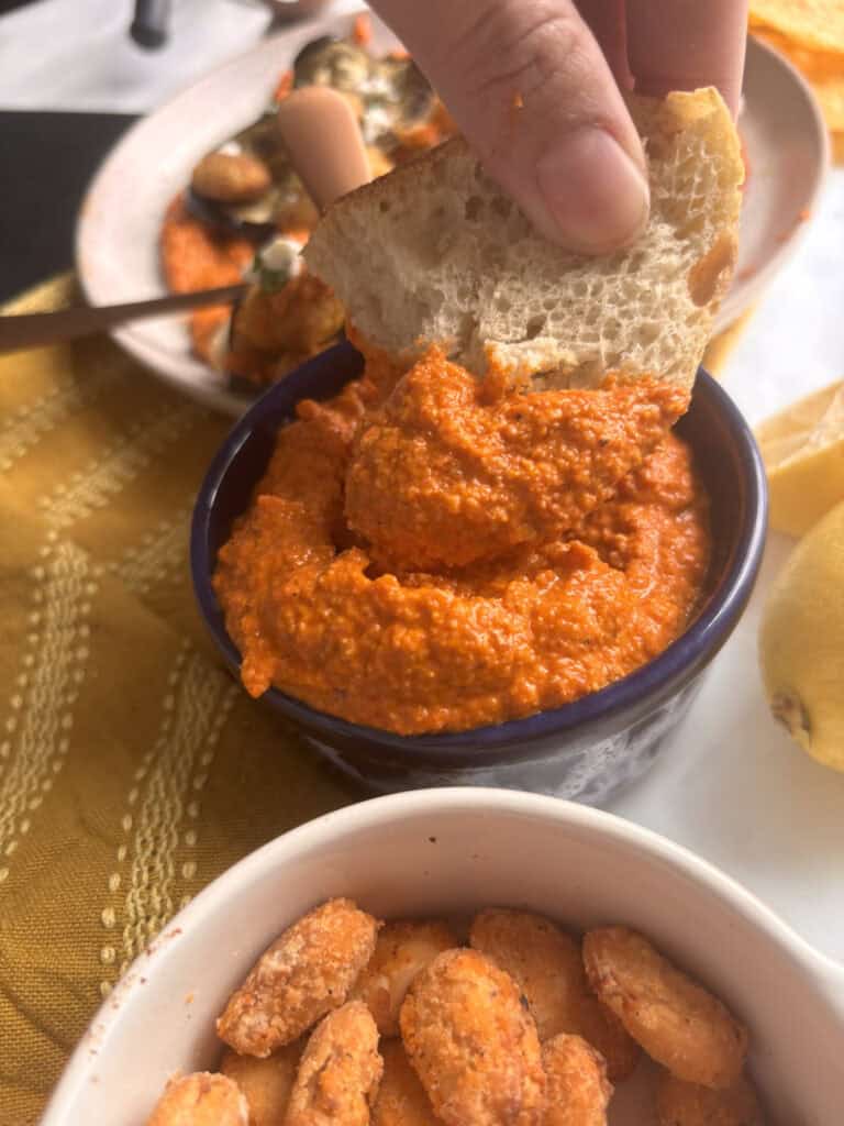Romesco sauce - with bread being dipped into it