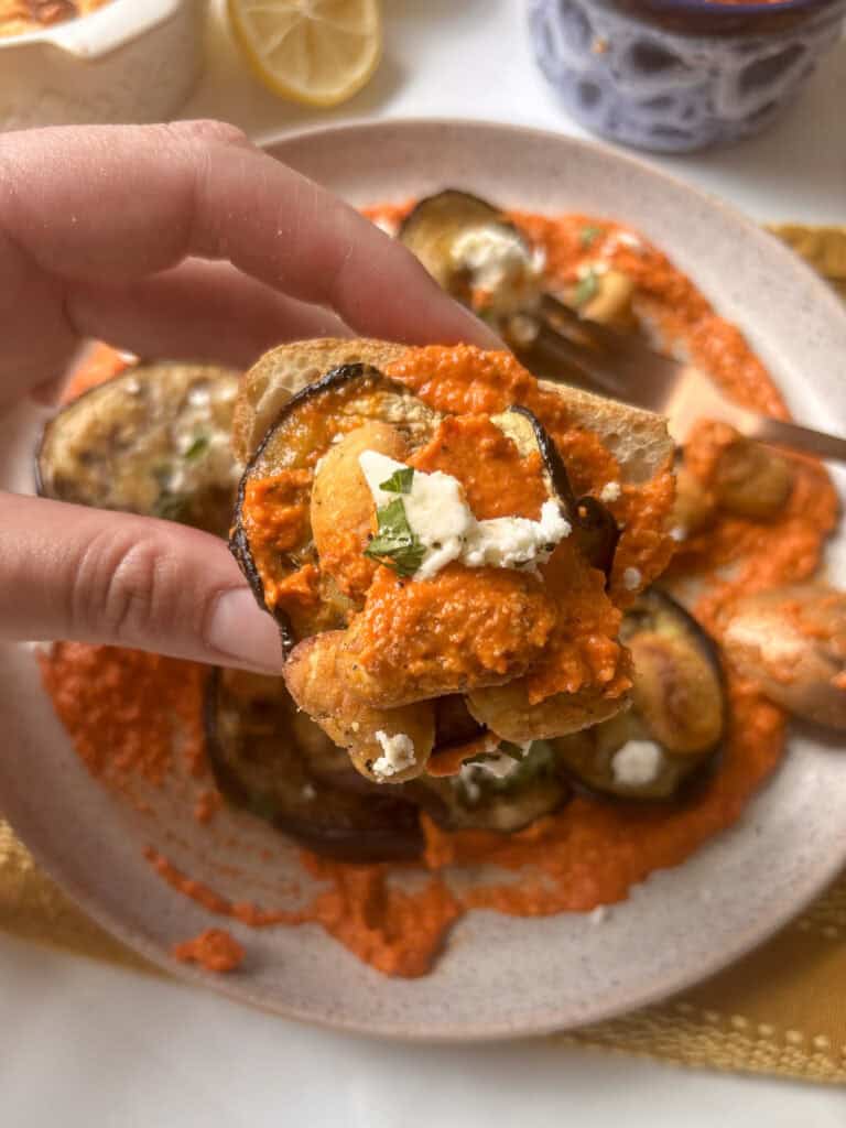 crispy butter beans, romesco sauce, and roasted eggplant loaded up onto a slice of sourdough