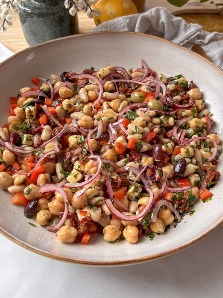 The dense bean salad once it has been mixed, with lots of beans and vegetables