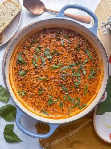 a casserole pan of marry me lentils topped with fresh basil