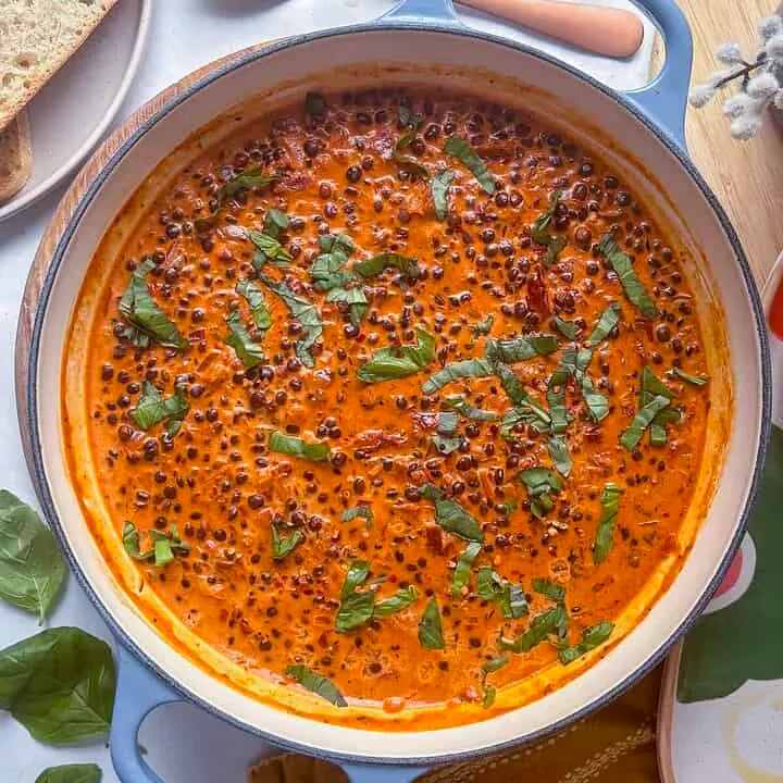 a casserole pan of marry me lentils topped with fresh basil