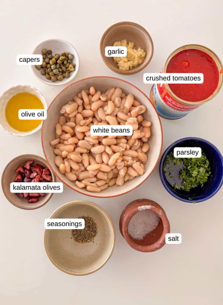 ingredients list for puttanesca white beans: white beans, crushed tomatoes, garlic, capers, parsley, kalamata olives, olive oil, salt, seasonings