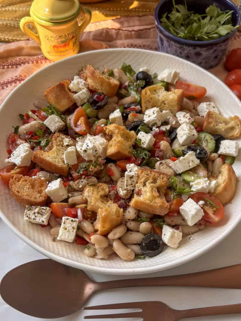 side view of the Italian bean salad in a bowl, topped with dried oregano