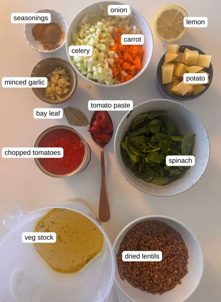 Ingredients needed for lentil soup: onion, carrot, celery, lemon, potato, garlic, seasonings, tomato paste, bay leaf, chopped tomatoes, spinach, vegetable stock, dried lentils