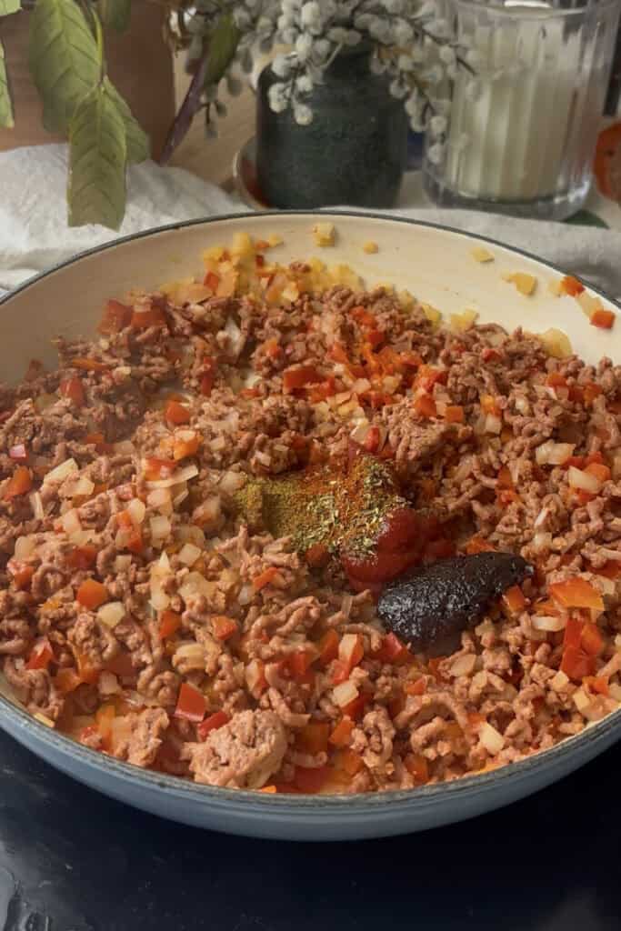 chipotle paste, tomato paste, and spices added to the pan