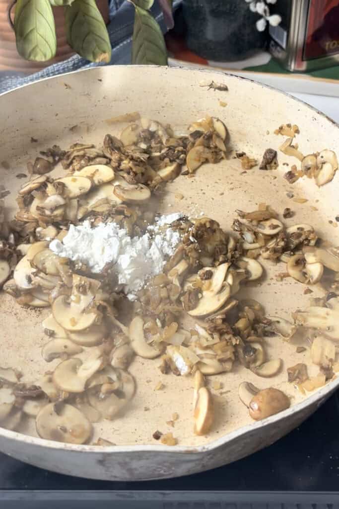 cornflour is added to the sauted mushrooms and onions mixture to thicken