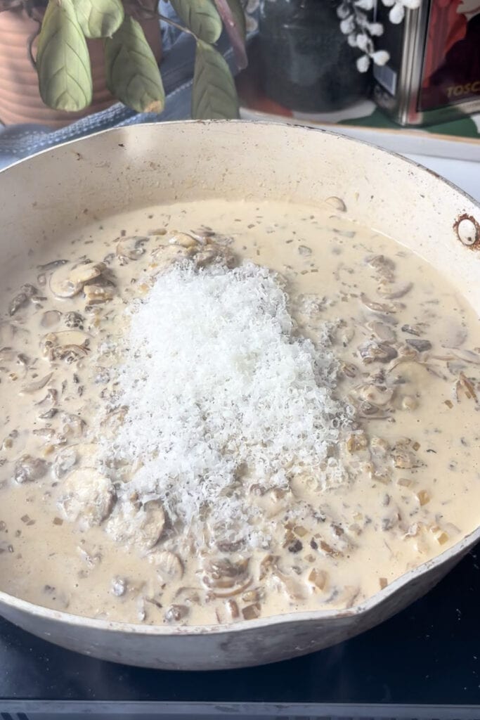 the creamy mushroom mixture is then topped with grated Pecorino cheese
