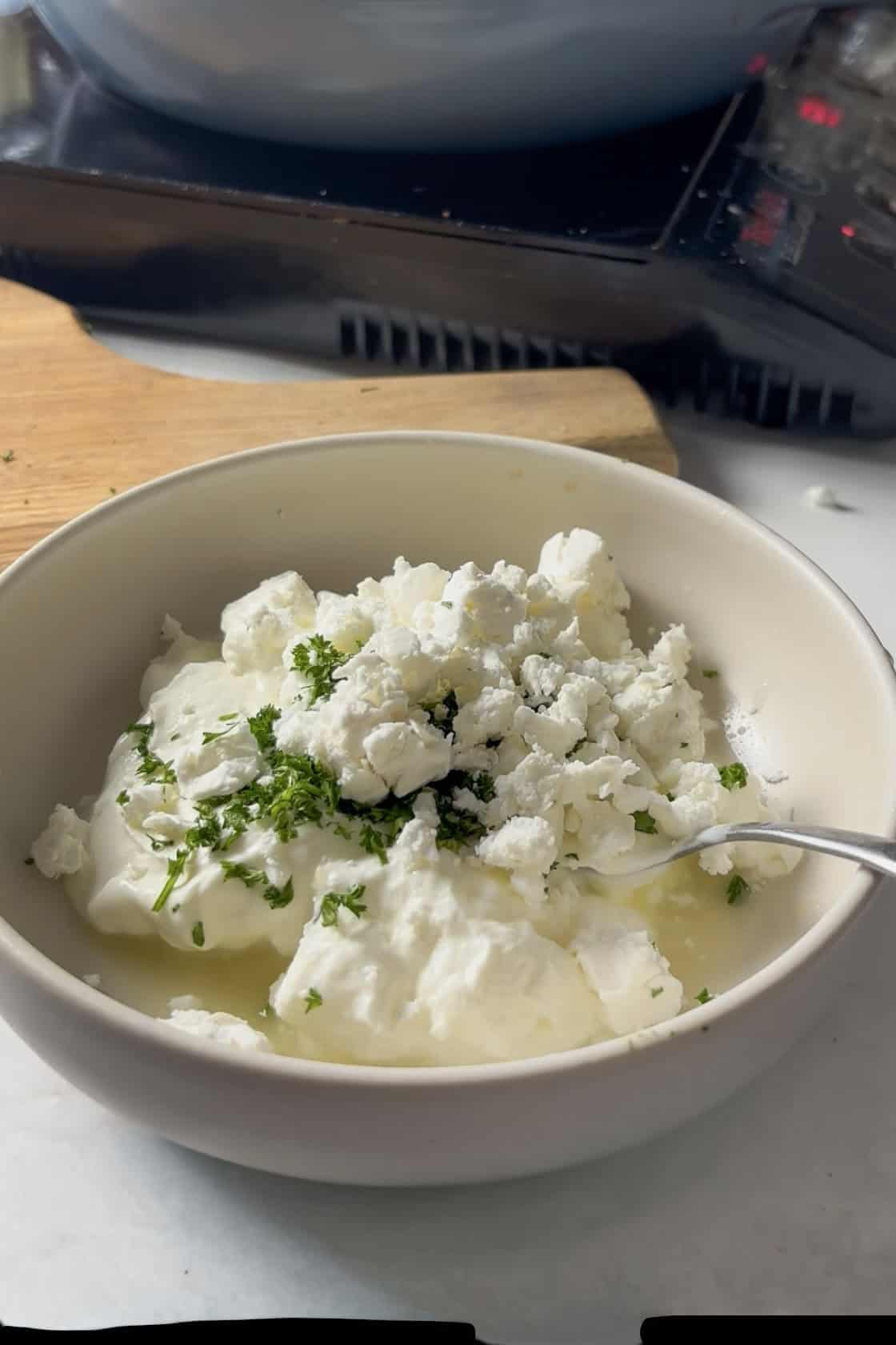 all ingredients for the feta yogurt pre-mixing - yogurt, feta, lemon juice, minced garlic, fresh parsley