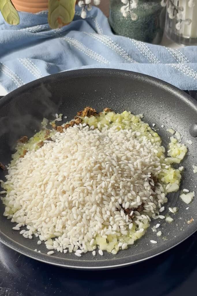 porcini mushrooms and risotto rice are added to the sauted onions and garlic and toasted for a couple of minutes