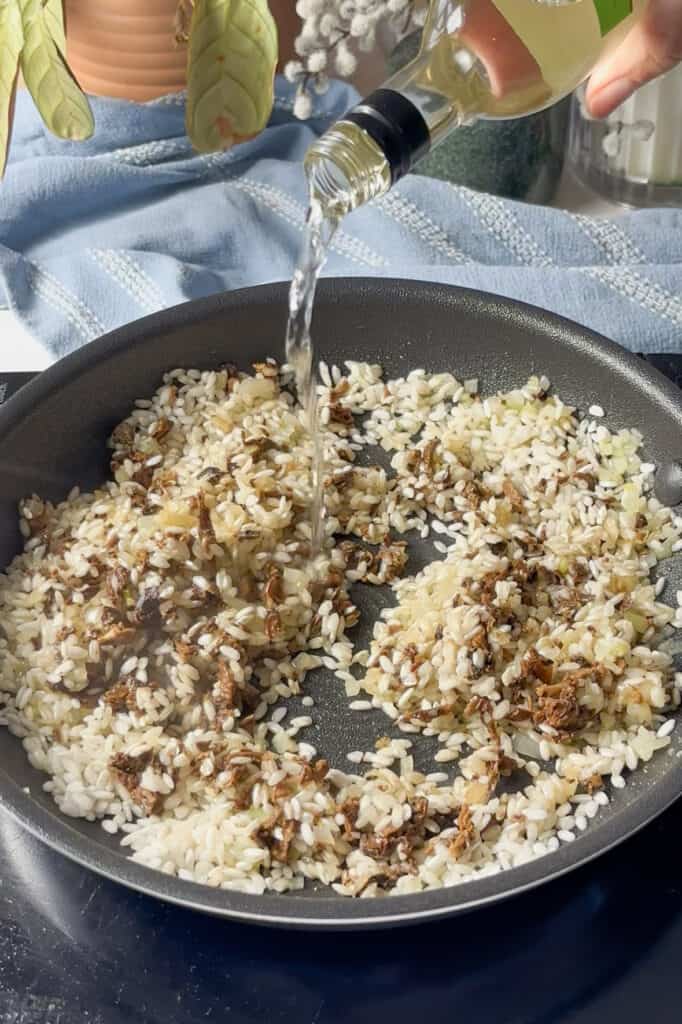 a splash of white wine is added to the pan with the risotto rice