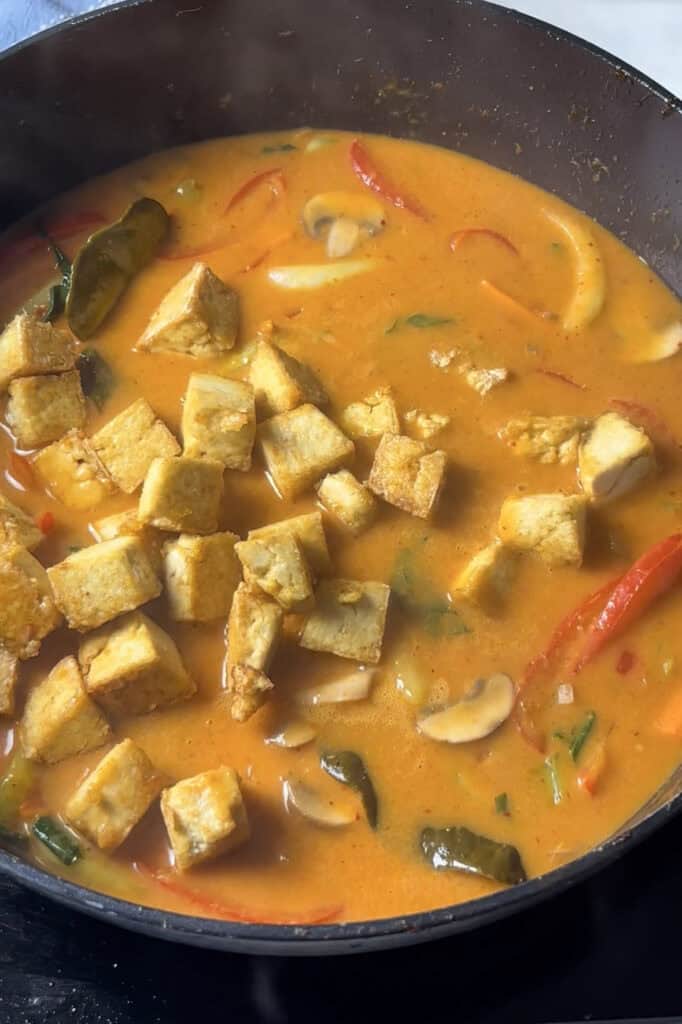 crispy tofu is added to the red thai curry sauce