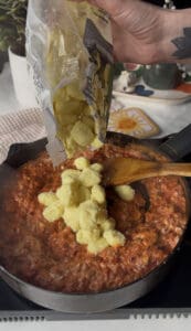 fresh gnocchi is added to the saucepan of creamy sun-dried tomato sauce