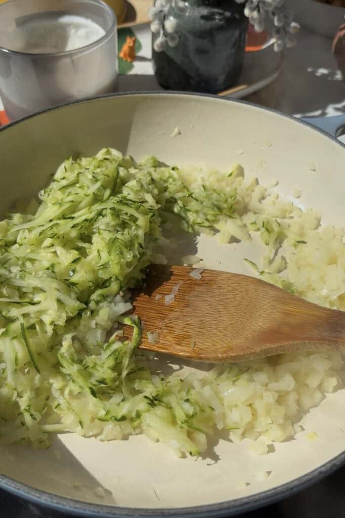 grated zucchini stirred into diced onion and garlic and cooked in butter