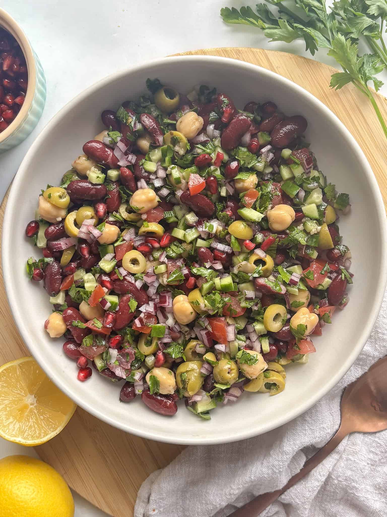 colorful mediterranean bean salad with chickpeas, kidney beans, and fresh salad vegetables