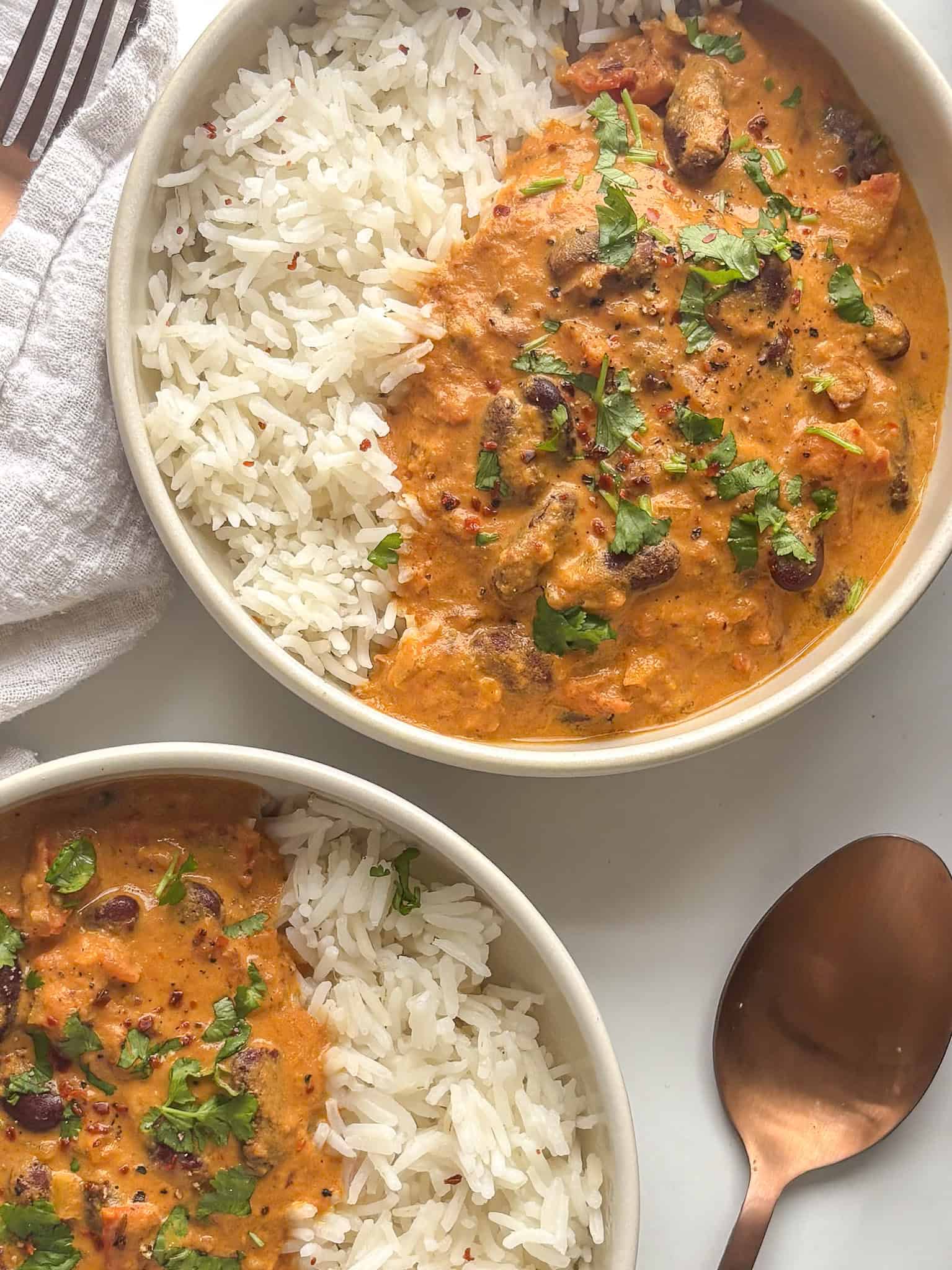rajma masala (kidney bean curry) served over rice and topped with cilantro