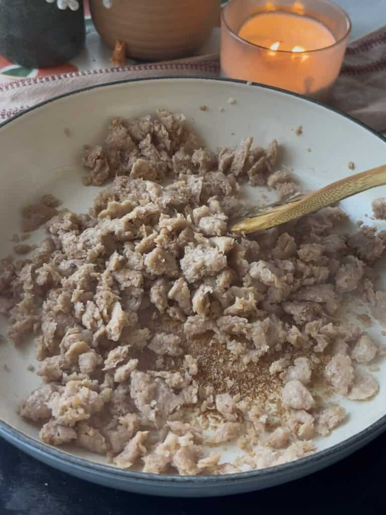 crumbled sausages in a pan, cooked until golden and crispy