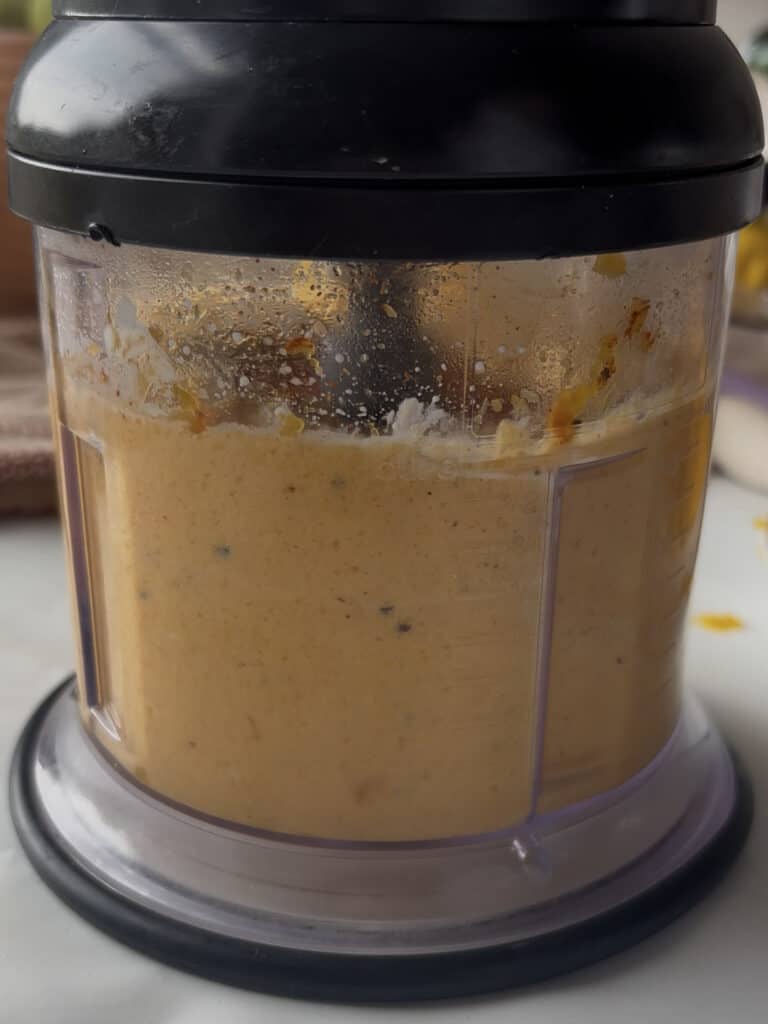 the butternut squash sauce for the butternut squash and spinach lasagne being blended until smooth