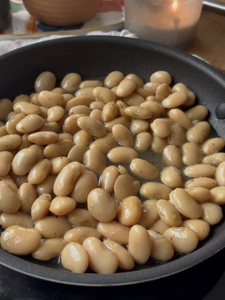 butter beans and a small amount of stock are added to the pepper, bloomed in butter, so the beans can begin to absorb the sauce