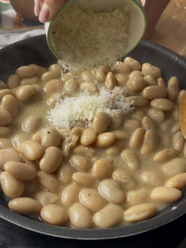 cheese is added to the peppery butter beans for a thick cheesy sauce